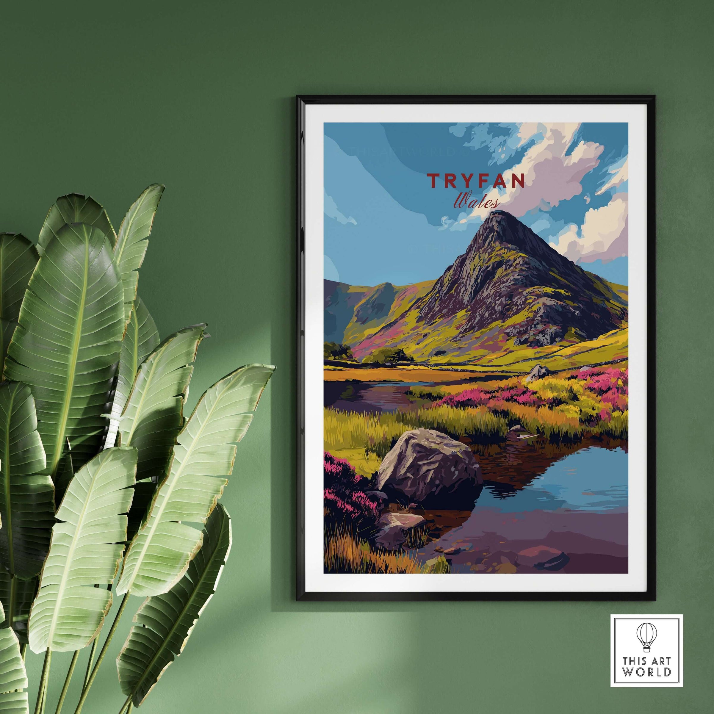 Tryfan Wales Mountain Landscape Print - Snowdonia Valley Wall Art framed on green wall with plants.