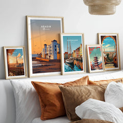 Agadir Travel Poster – Morocco Beach Print in a gallery wall set of five framed travel prints in natural wood frames above a bed