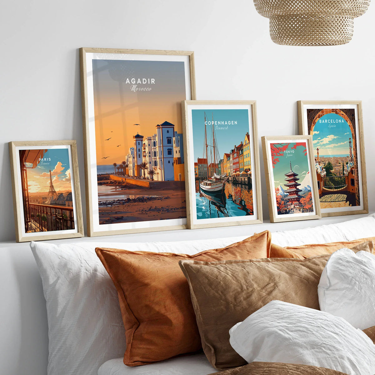 Agadir Travel Poster – Morocco Beach Print in a gallery wall set of five framed travel prints in natural wood frames above a bed