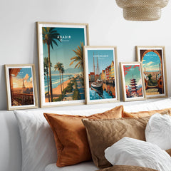 Agadir Travel Poster Print Morocco - Palm Trees in a gallery wall set of five framed travel prints in natural wood frames above a bed
