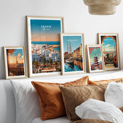 Agadir Travel Poster – City Skyline in a gallery wall set of five framed travel prints in natural wood frames above a bed