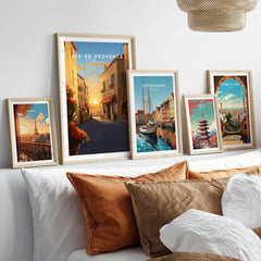 Aix-en-Provence Poster in a gallery wall set of five framed travel prints in natural wood frames above a bed