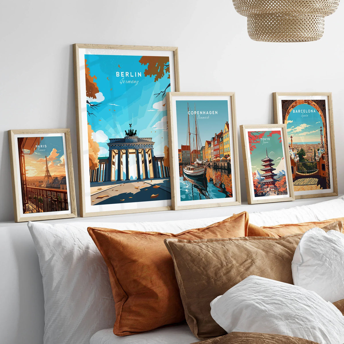 Berlin Poster Blue Sky in a gallery wall set of five framed travel prints in natural wood frames above a bed