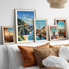 Big Sur Print in a gallery wall set of five framed travel prints in natural wood frames above a bed