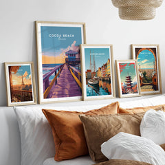 Cocoa Beach Boardwalk Print - Florida Sunset Wall Art in a gallery wall set of five framed travel prints in natural wood frames above a bed