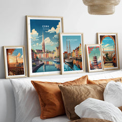 Cork City Ireland Print in a gallery wall set of five framed travel prints in natural wood frames above a bed