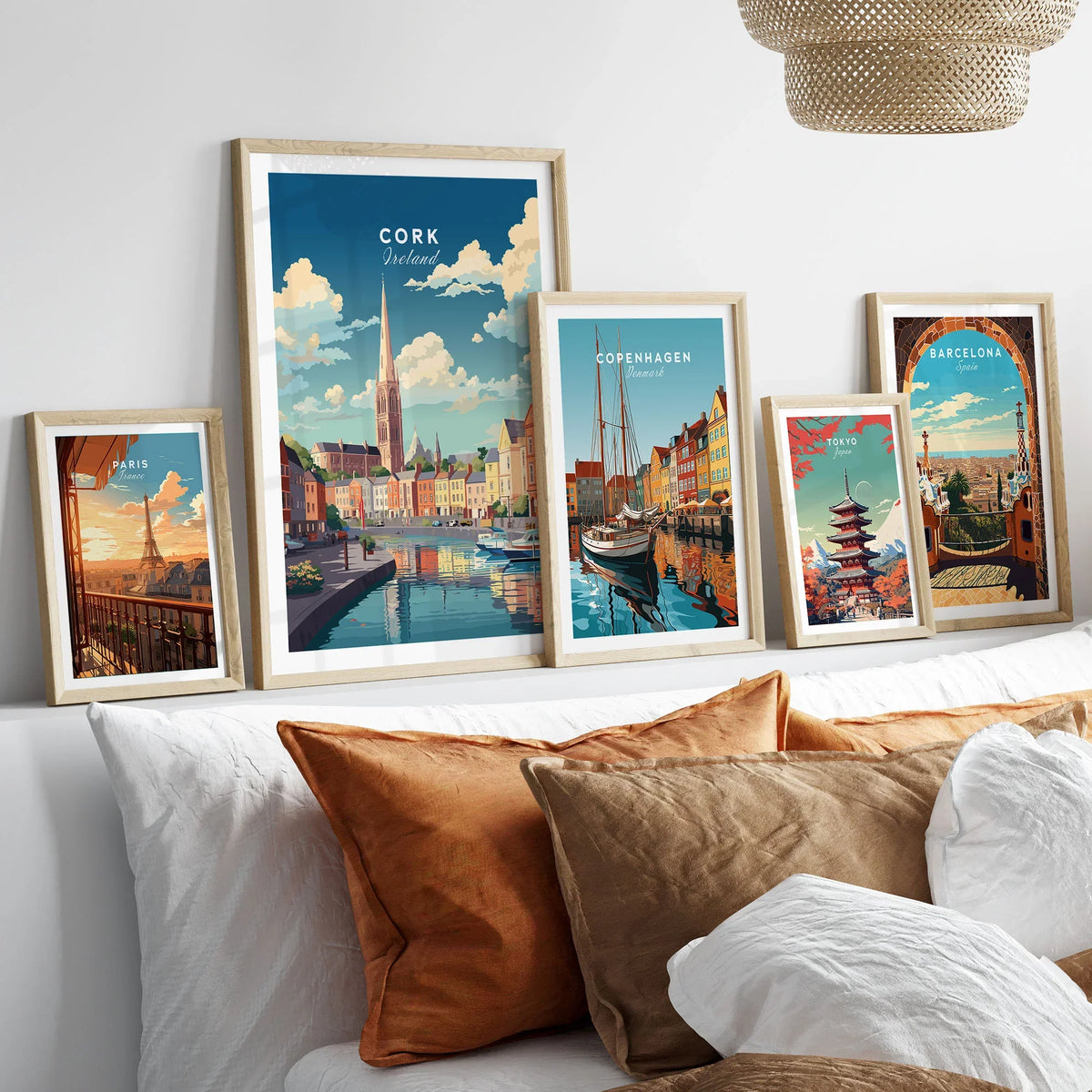 Cork City Ireland Print in a gallery wall set of five framed travel prints in natural wood frames above a bed