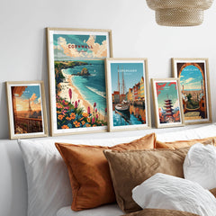 Cornwall Wall Art Print - United Kingdom Travel Poster in a gallery wall set of five framed travel prints in natural wood frames above a bed