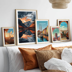 Glencoe Wall Art in a gallery wall set of five framed travel prints in natural wood frames above a bed