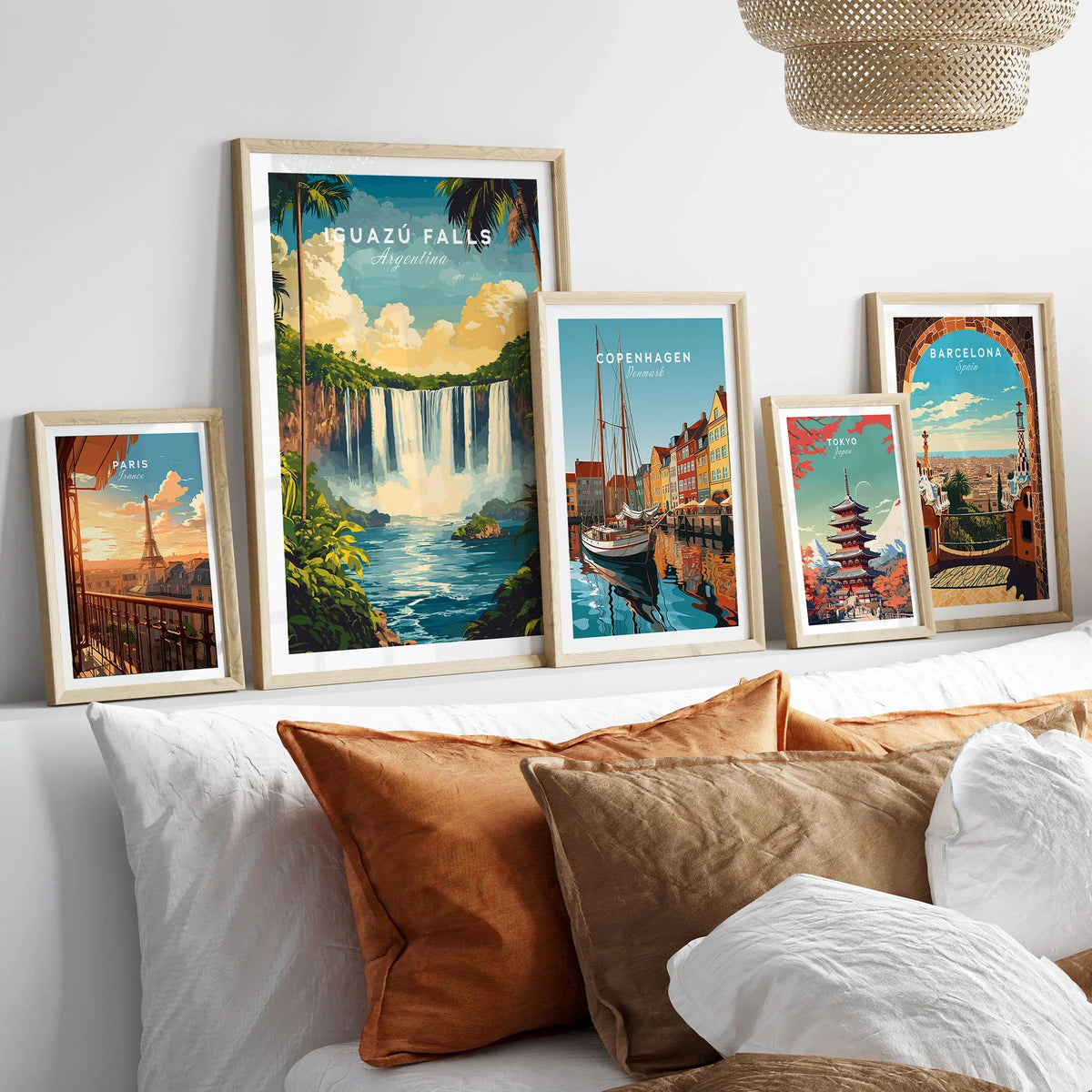 Iguazu Falls Wall Art in a gallery wall set of five framed travel prints in natural wood frames above a bed