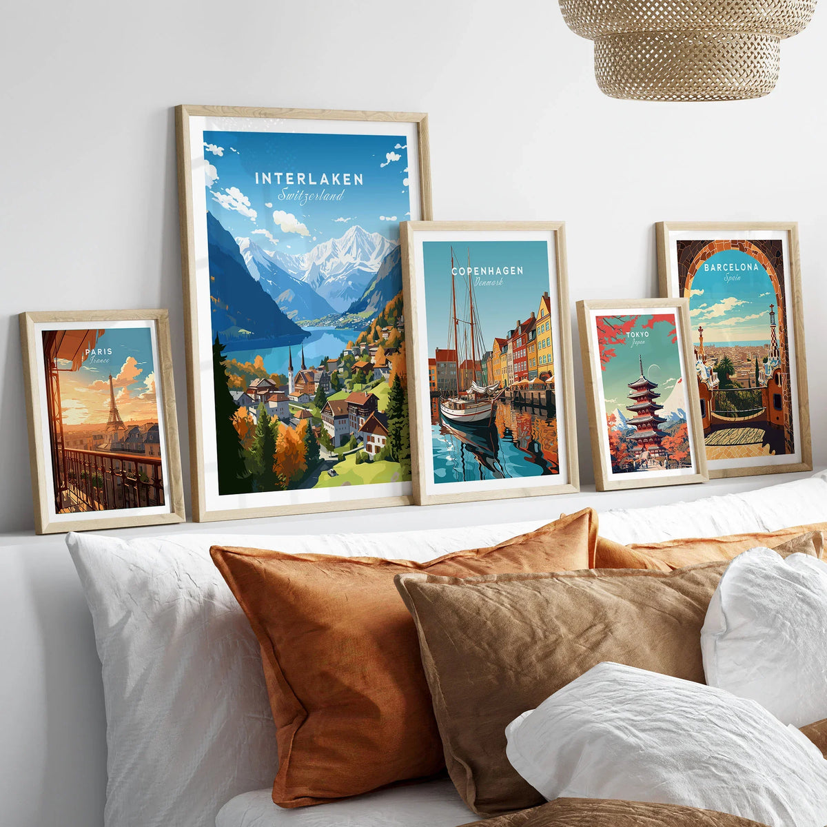 Interlaken Poster in a gallery wall set of five framed travel prints in natural wood frames above a bed