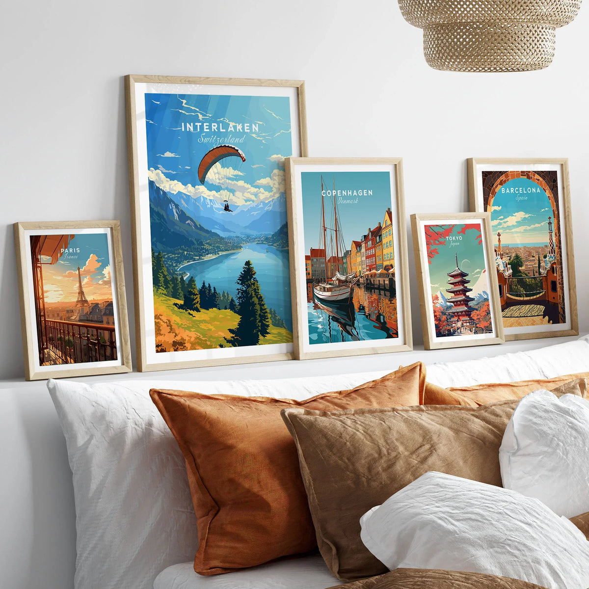Interlaken Switzerland Poster in a gallery wall set of five framed travel prints in natural wood frames above a bed