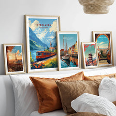 Interlaken Travel Print in a gallery wall set of five framed travel prints in natural wood frames above a bed