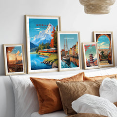 Interlaken Print Switzerland in a gallery wall set of five framed travel prints in natural wood frames above a bed