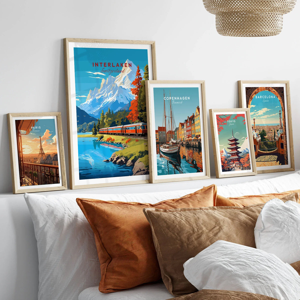 Interlaken Print Switzerland in a gallery wall set of five framed travel prints in natural wood frames above a bed