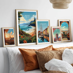Kauai Print in a gallery wall set of five framed travel prints in natural wood frames above a bed