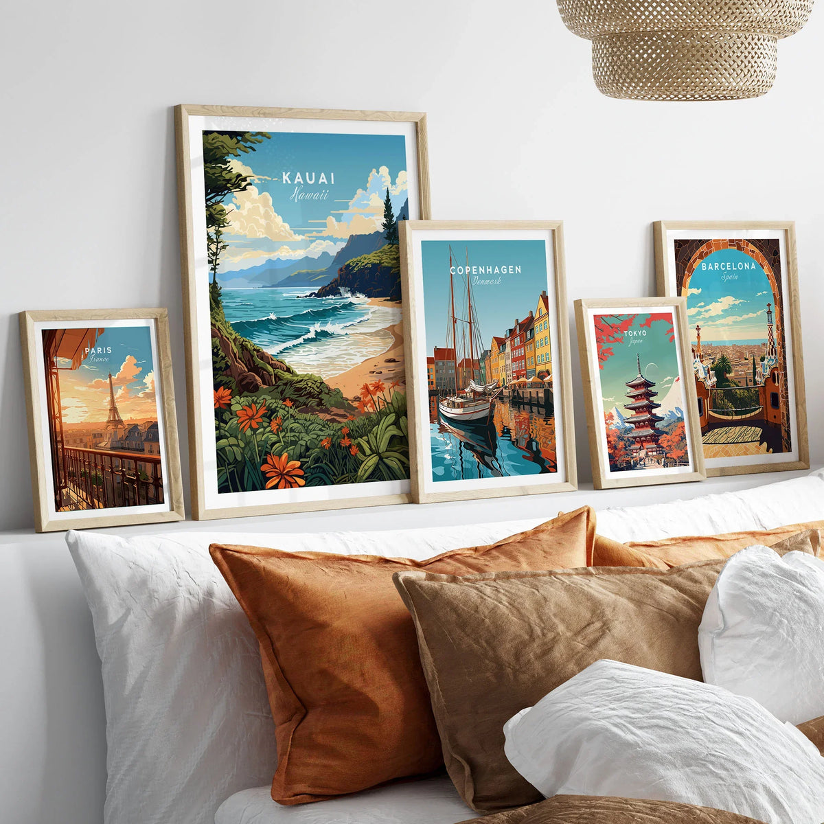 Kauai Print in a gallery wall set of five framed travel prints in natural wood frames above a bed