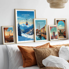 Kitzbuhel Art Print in a gallery wall set of five framed travel prints in natural wood frames above a bed