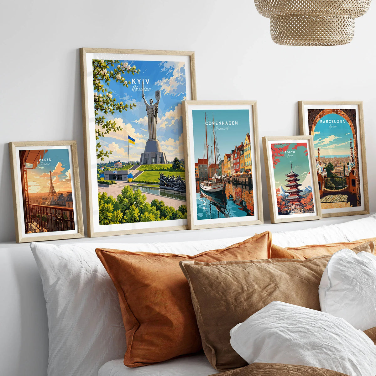 Kyiv Ukraine Motherland Monument Travel Poster — the Motherland Monument under spring blossom with the Ukrainian flag flying, shown as set five framed artprints above bed natural wood frames