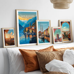 Lake Maggiore Print in a gallery wall set of five framed travel prints in natural wood frames above a bed