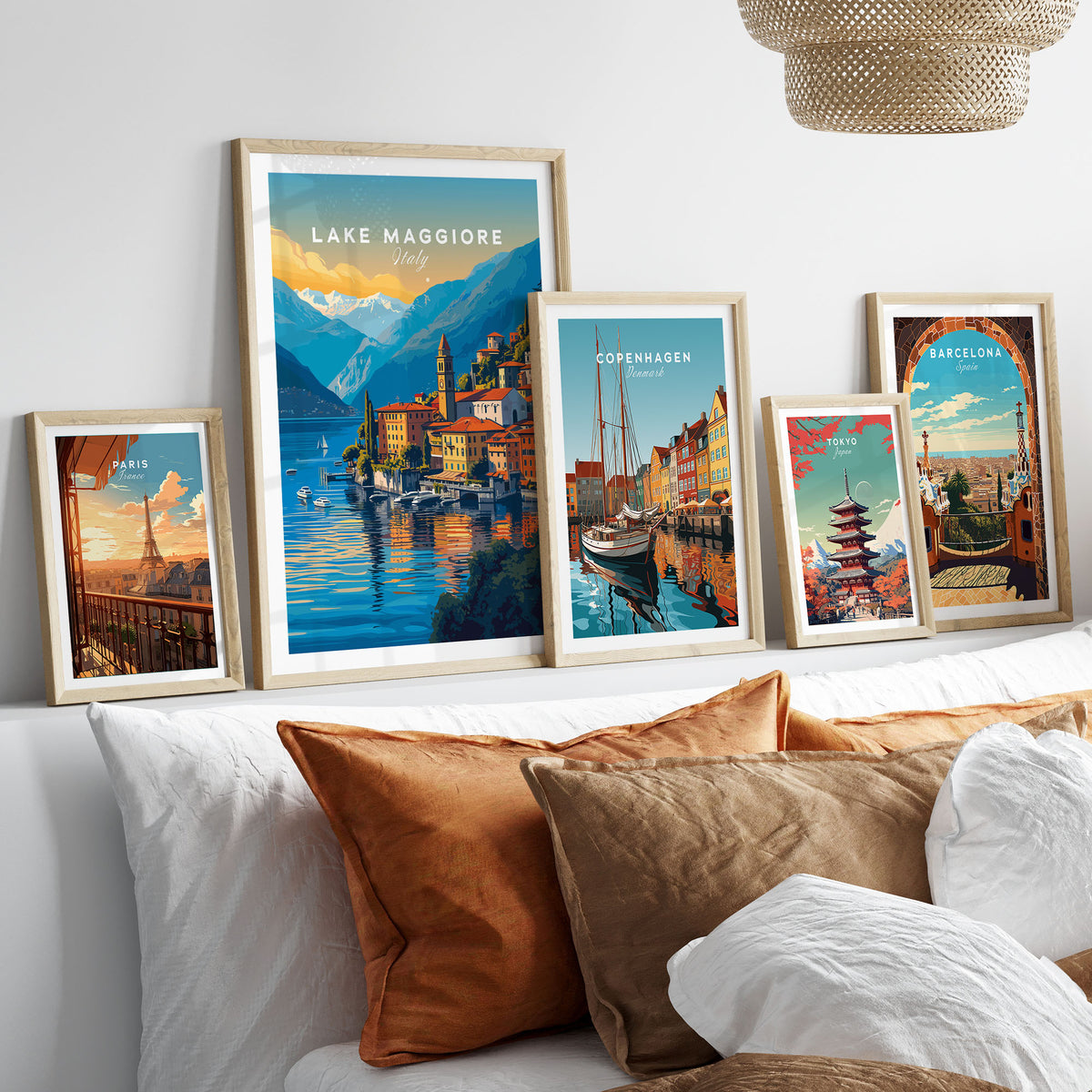 Lake Maggiore Print in a gallery wall set of five framed travel prints in natural wood frames above a bed