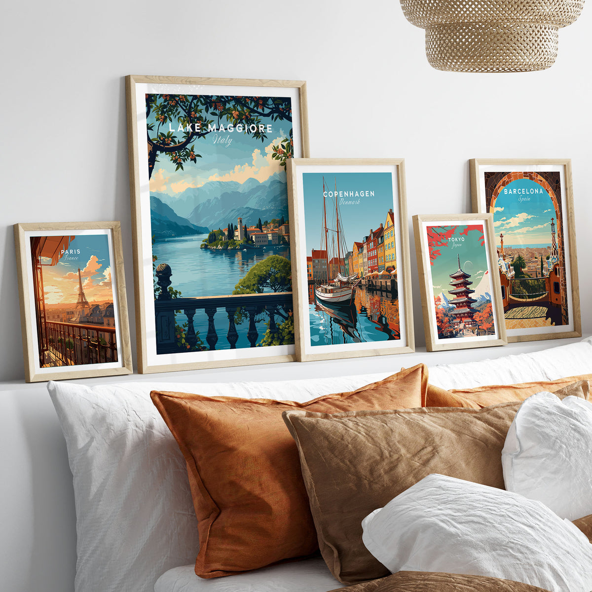 Lake Maggiore Travel Poster in a gallery wall set of five framed travel prints in natural wood frames above a bed