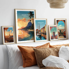 Le Morne Mauritius Poster in a gallery wall set of five framed travel prints in natural wood frames above a bed