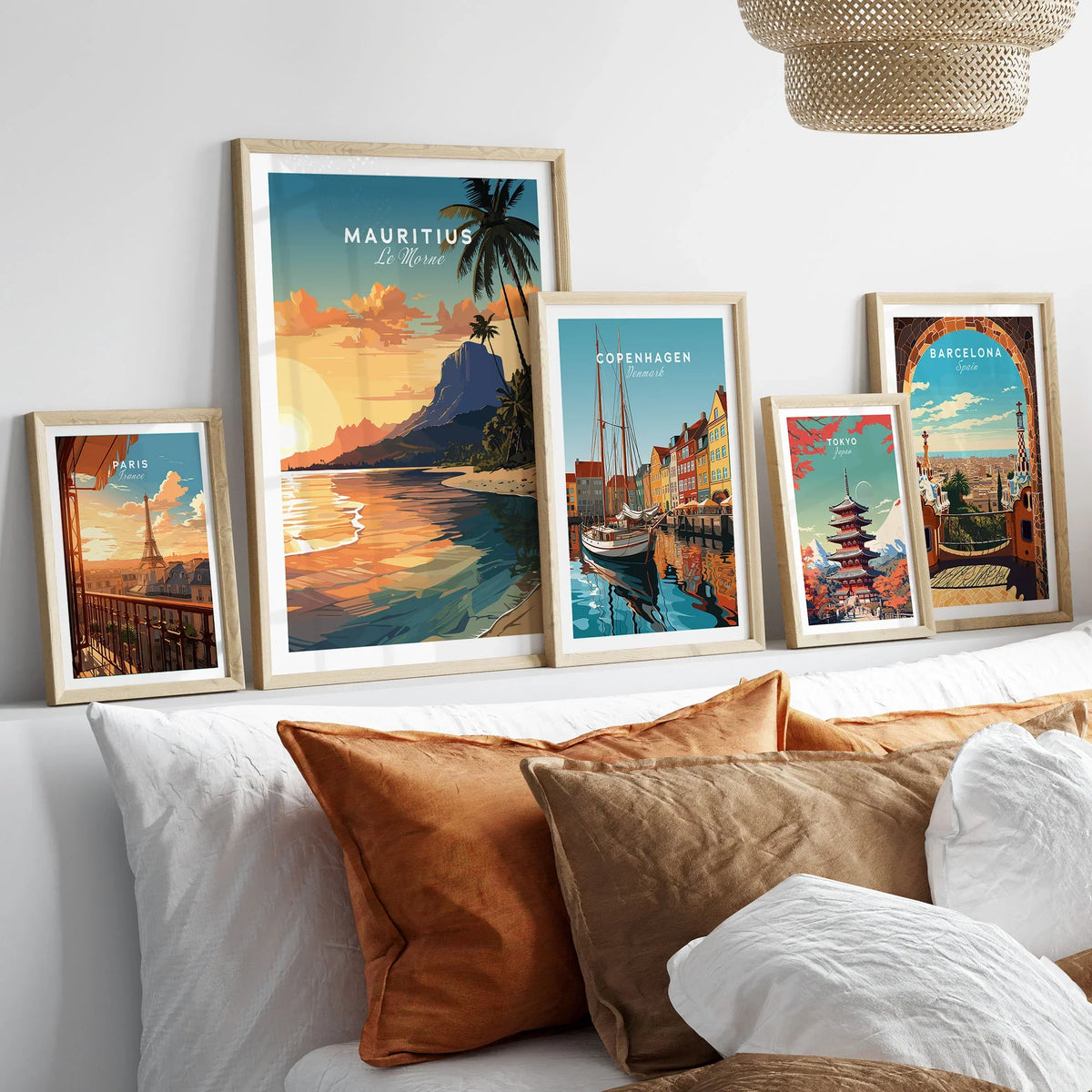 Le Morne Mauritius Poster in a gallery wall set of five framed travel prints in natural wood frames above a bed
