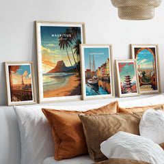 Mauritius Le Morne Poster in a gallery wall set of five framed travel prints in natural wood frames above a bed