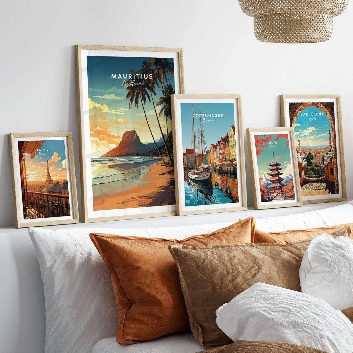Mauritius Le Morne Poster in a gallery wall set of five framed travel prints in natural wood frames above a bed