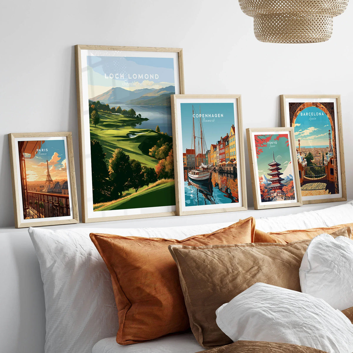 Loch Lomond Scotland Autumn Lochside Travel Poster — autumn slopes rolling down to Loch Lomond with Highland hills beyond, shown as set five framed artprints above bed natural wood frames