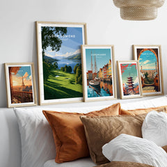 Loch Lomond Scotland Summer Shore Travel Poster — a sunlit grassy shoreline running down to Loch Lomond under old oaks, shown as set five framed artprints above bed natural wood frames