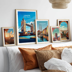 London Print England in a gallery wall set of five framed travel prints in natural wood frames above a bed