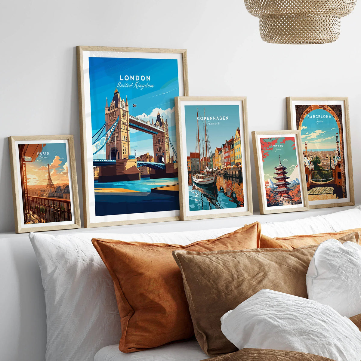 London Print England in a gallery wall set of five framed travel prints in natural wood frames above a bed