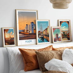 Agadir Morocco Wall Art in a gallery wall set of five framed travel prints in natural wood frames above a bed