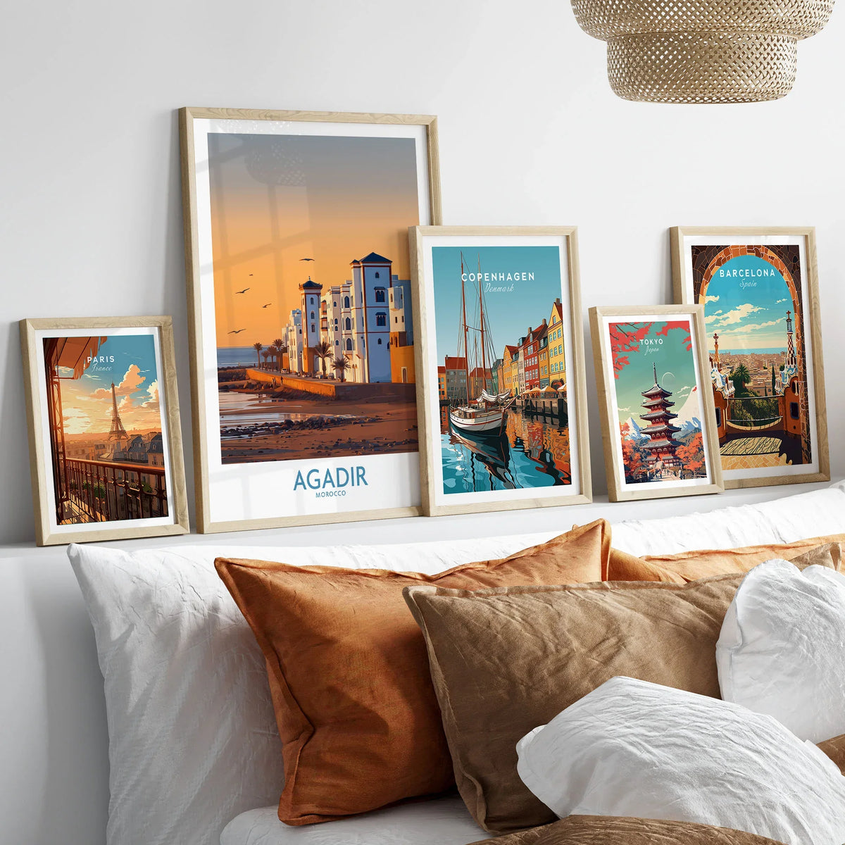 Agadir Morocco Wall Art in a gallery wall set of five framed travel prints in natural wood frames above a bed