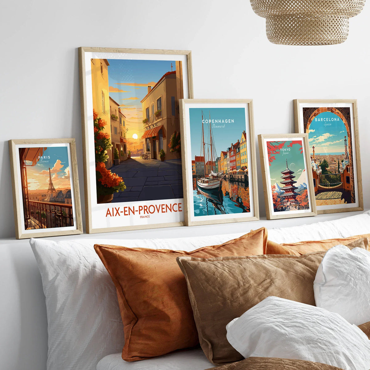 Aix-en-Provence Wall Art in a gallery wall set of five framed travel prints in natural wood frames above a bed
