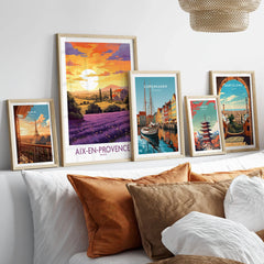 Aix-en-Provence Art Print in a gallery wall set of five framed travel prints in natural wood frames above a bed
