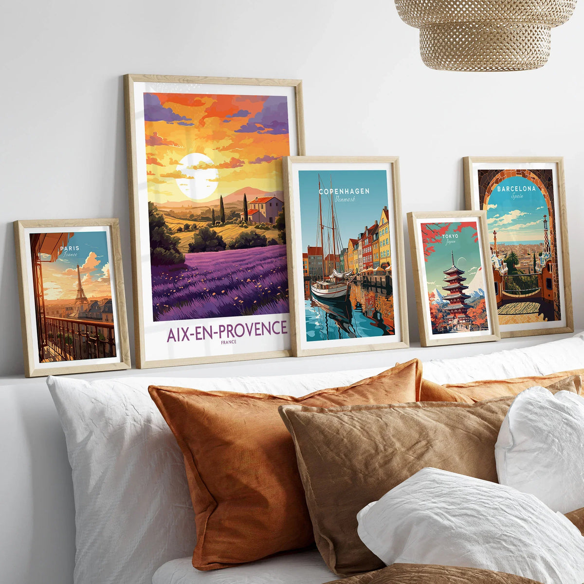 Aix-en-Provence Art Print in a gallery wall set of five framed travel prints in natural wood frames above a bed