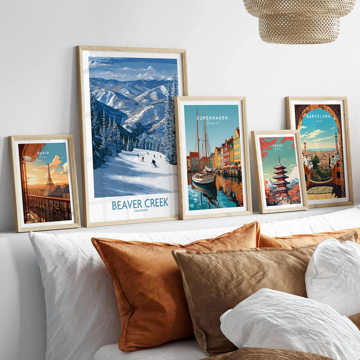 Beaver Creek Colorado Winter Wonderland Wall Art - Group Skiing Landscape in a gallery wall set of five framed travel prints in natural wood frames above a bed