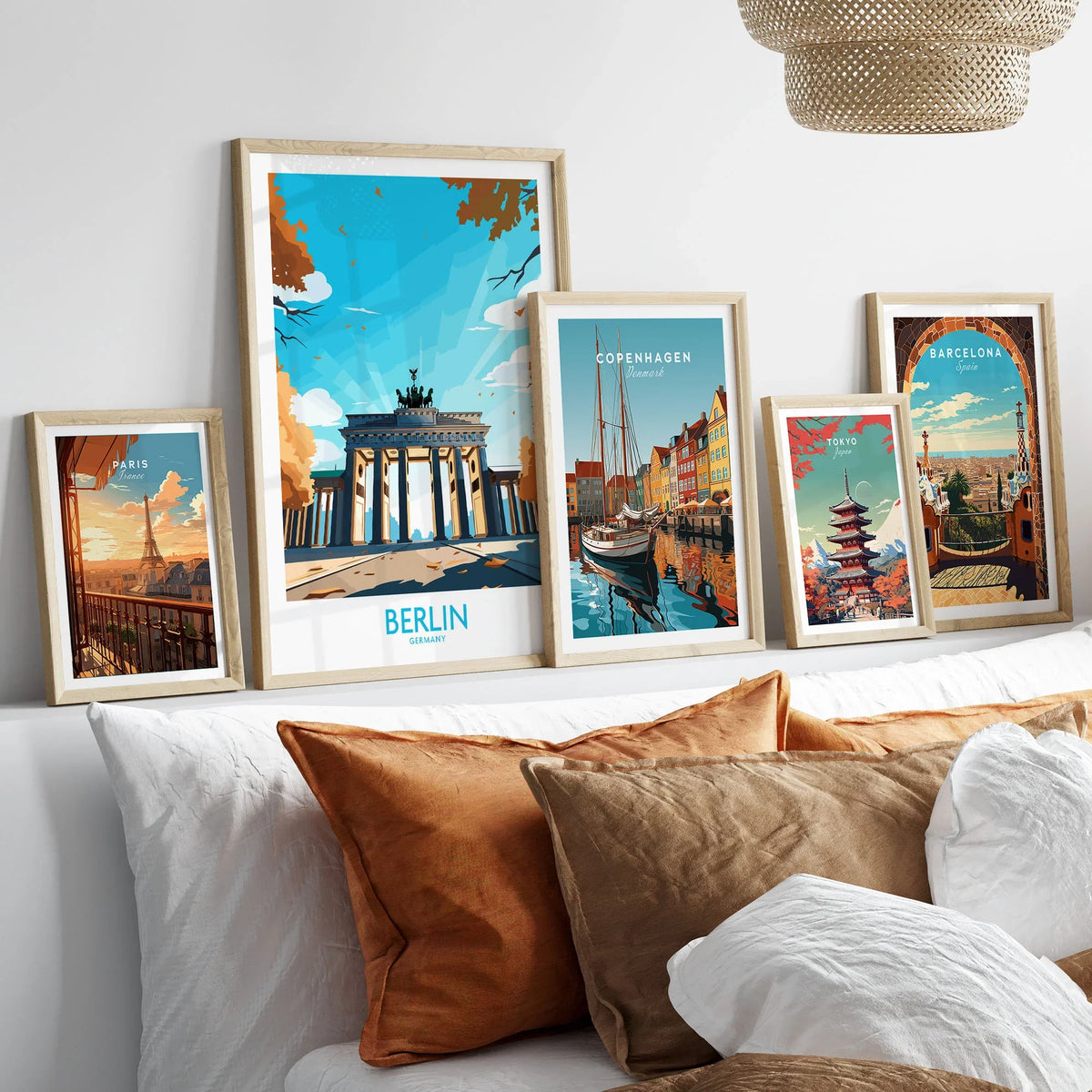 Berlin Wall Art Modern in a gallery wall set of five framed travel prints in natural wood frames above a bed