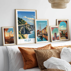 Big Sur Wall Art | Modern Style in a gallery wall set of five framed travel prints in natural wood frames above a bed