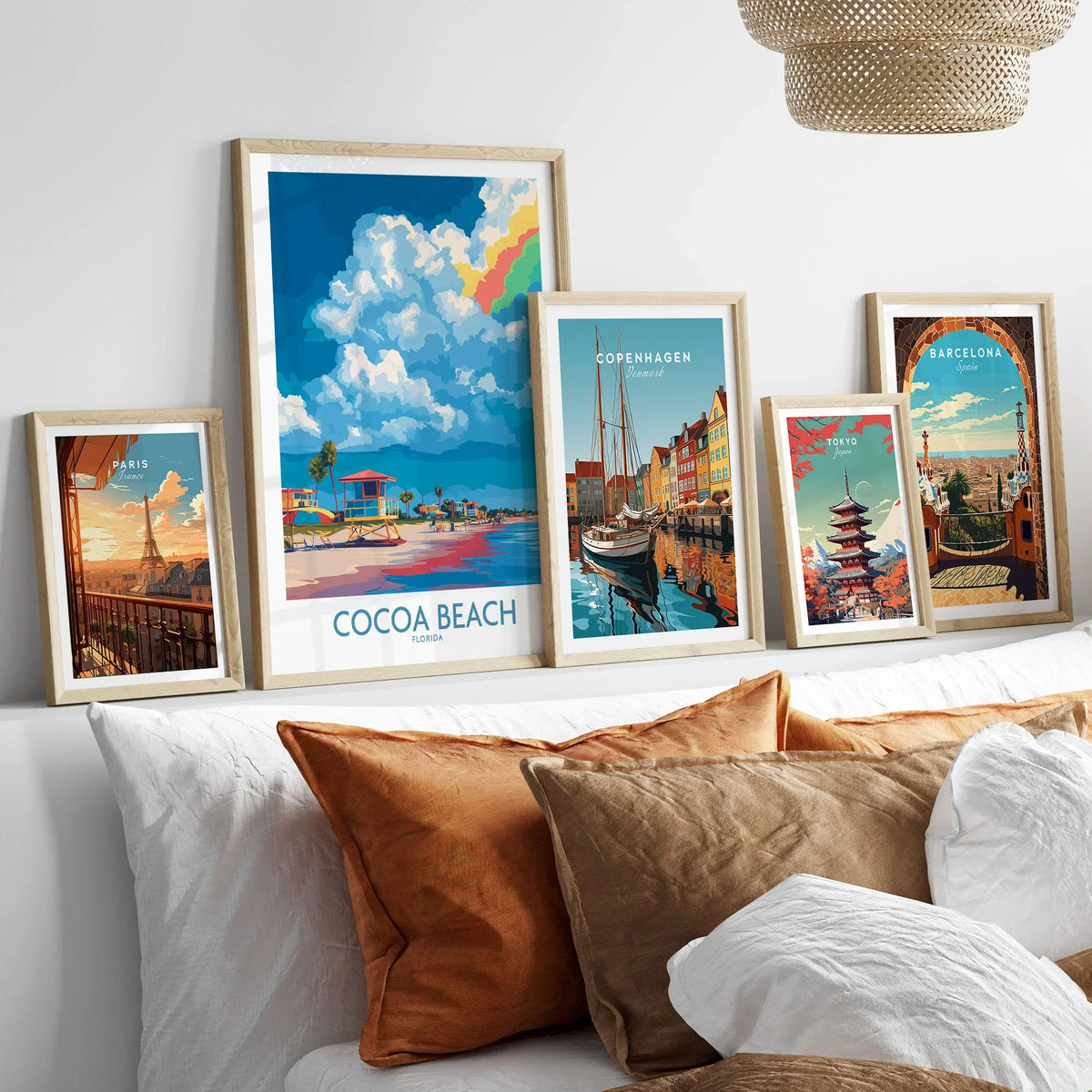 Cocoa Beach Rainbow Cloud Poster - Florida Travel Decor in a gallery wall set of five framed travel prints in natural wood frames above a bed