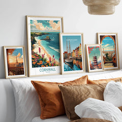 Cornwall Travel Poster - United Kingdom in a gallery wall set of five framed travel prints in natural wood frames above a bed
