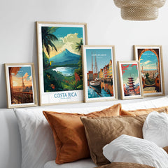 Costa Rica Wall Art | Modern Style in a gallery wall set of five framed travel prints in natural wood frames above a bed
