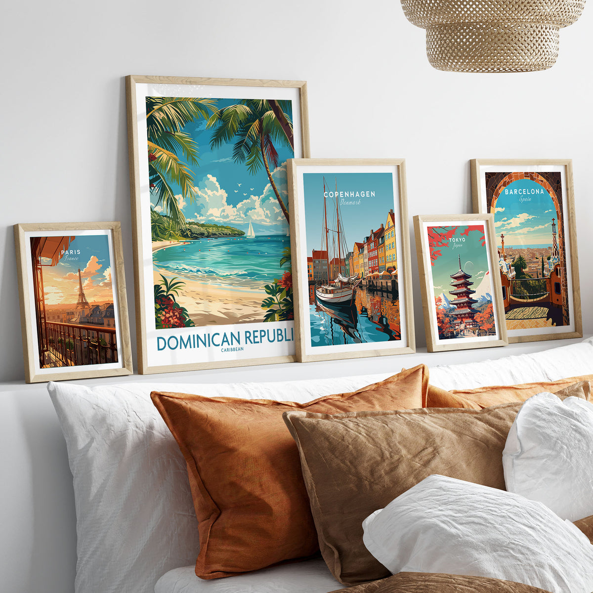 Dominican Republic Poster in a gallery wall set of five framed travel prints in natural wood frames above a bed