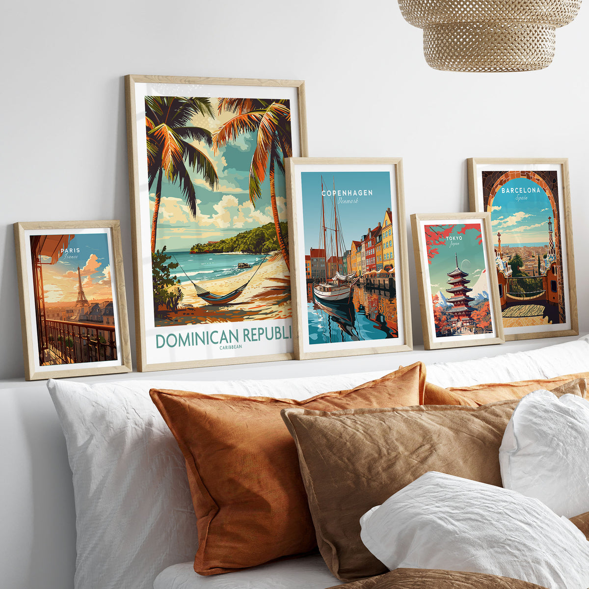 Dominican Republic Print in a gallery wall set of five framed travel prints in natural wood frames above a bed