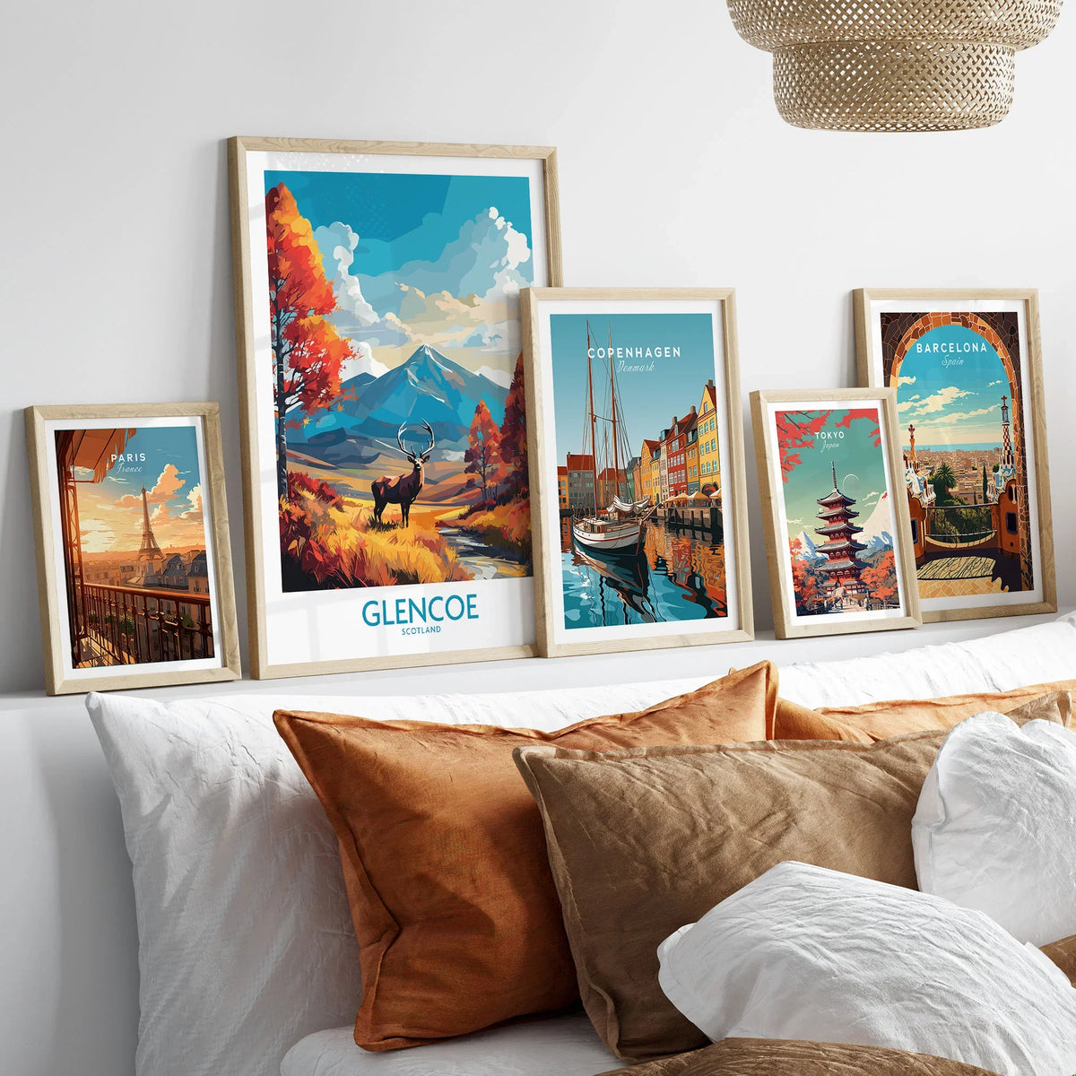 Glencoe Art Print Modern in a gallery wall set of five framed travel prints in natural wood frames above a bed