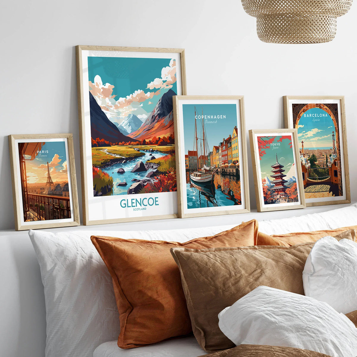 Glencoe Poster Print Modern in a gallery wall set of five framed travel prints in natural wood frames above a bed