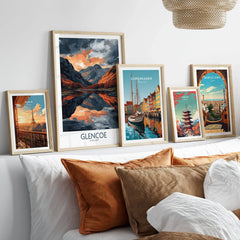Glencoe Wall Art Poster in a gallery wall set of five framed travel prints in natural wood frames above a bed